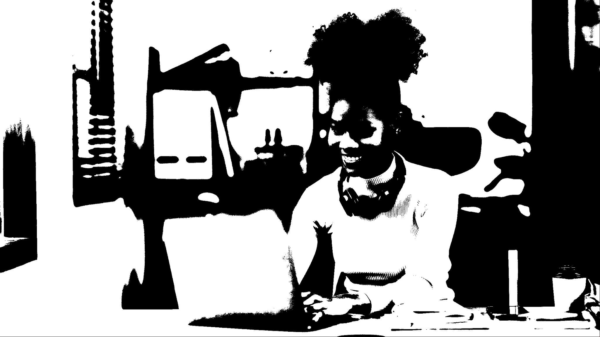 Beautiful young black woman working with laptop computer at home. Young african american female curly hair working on laptop and take note at home.